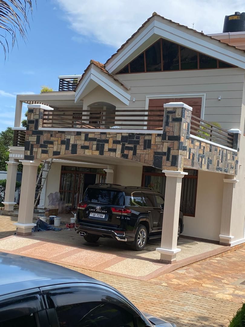 Contemporary residential exterior repaint with stone balcony detailing